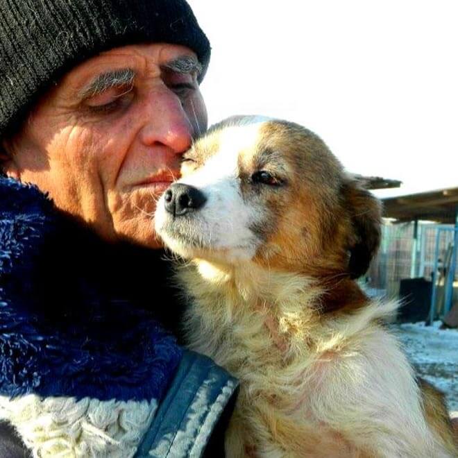 A man holding his rescue dog